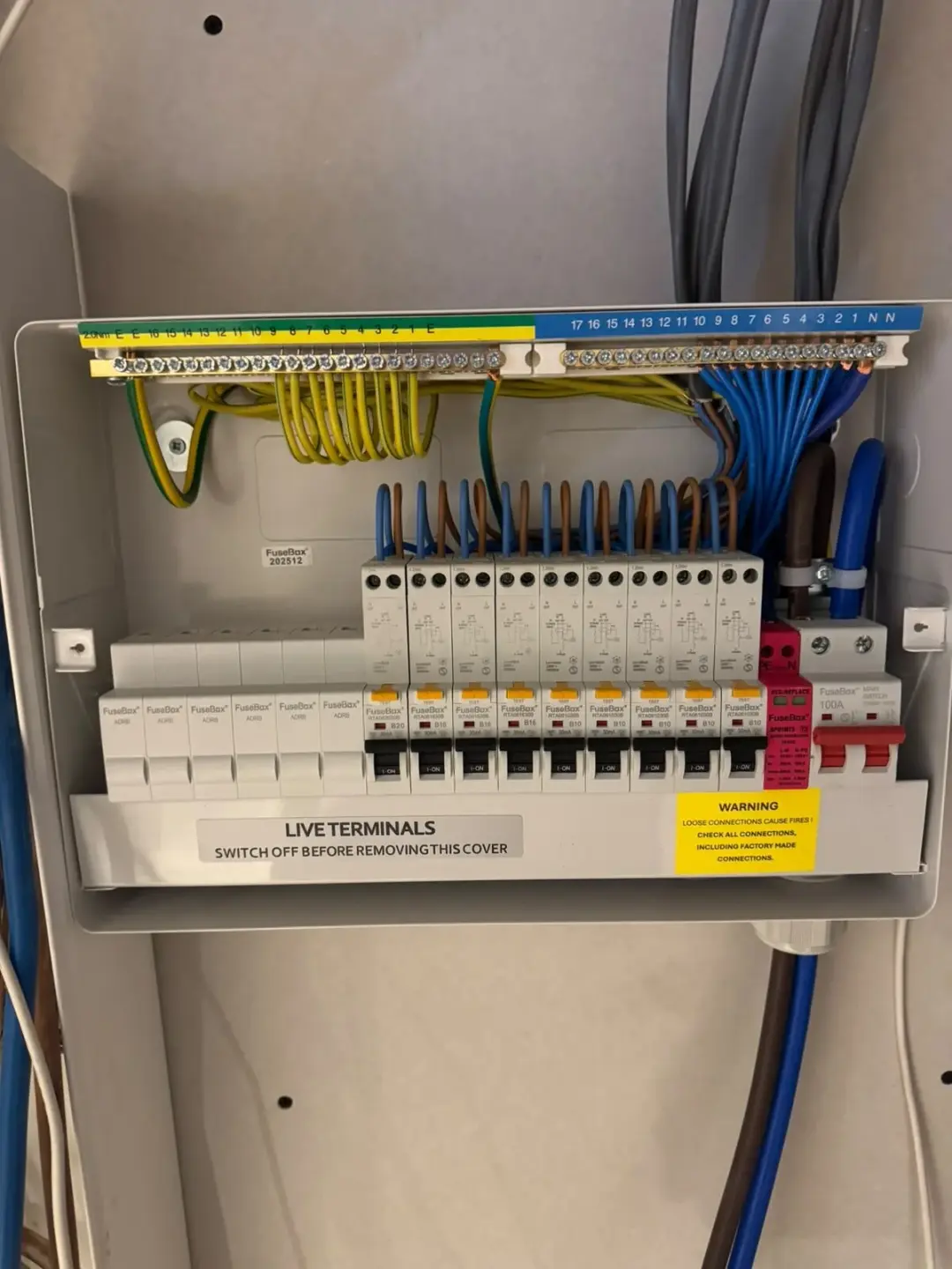 Open consumer unit showing new breakers and tidy wiring